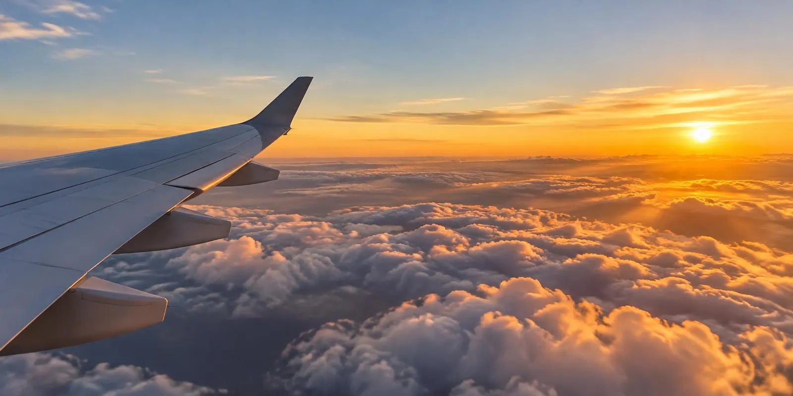 View of clouds from an airplane window at sunset